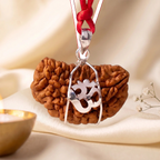 VASTUKOSHA 1 Mukhi Rudraksha pendant in a Kaju shape with a silver Om symbol, worn on a red thread.