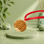 VASTUKOSHA 6 Mukhi Nepal origin Rudraksha bead on a red cord, displayed on a green marble pedestal.