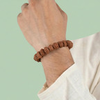VASTUKOSHA 7 Mukhi Rudraksha bead bracelet worn on a wrist, featuring natural brown textured spiritual prayer beads.