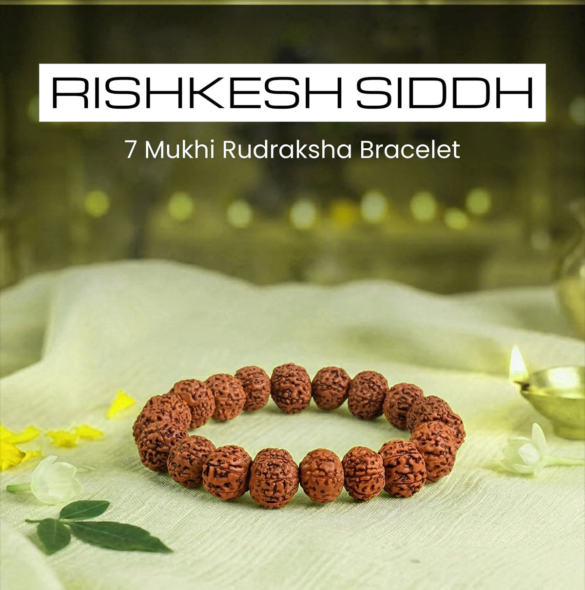 VASTUKOSHA 7 Mukhi Rudraksha bead bracelet for wealth and luck, resting on a white cloth with a lit diya lamp