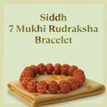 VASTUKOSHA Siddh 7 Mukhi Rudraksha bracelet featuring natural brown beads on a soft cloth, symbolizing spiritual prosperity.