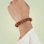 VASTUKOSHA 7 Mukhi Nepal Rudraksha bead bracelet worn on a wrist for spiritual practice and prosperity