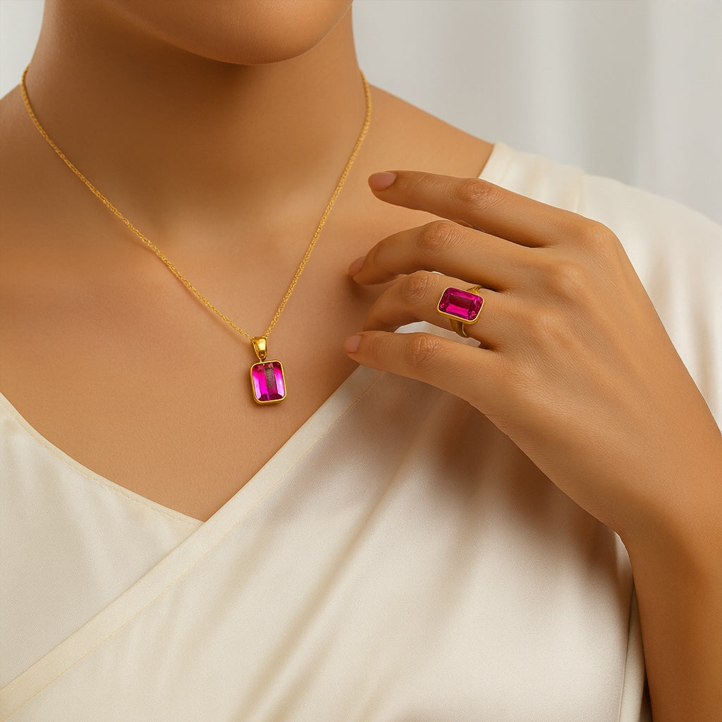 VASTUKOSHA natural African ruby gemstone set in a gold pendant and matching ring worn by a woman in a white dress