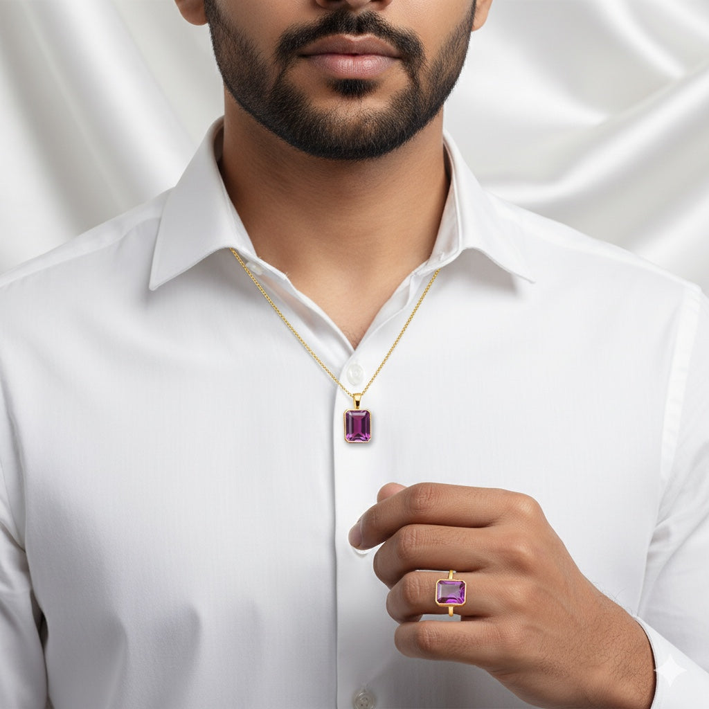 Man wearing a VASTUKOSHA African Ruby pendant and matching ring set in gold, styled with a crisp white shirt.
