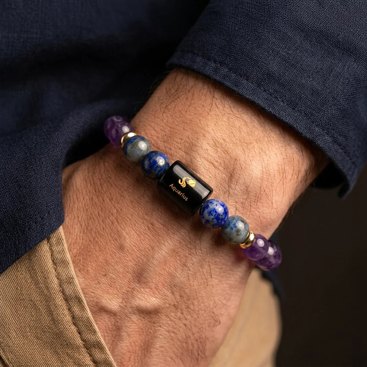 VASTUKOSHA Aquarius zodiac bracelet featuring purple amethyst and blue lapis lazuli beads on a person's wrist.