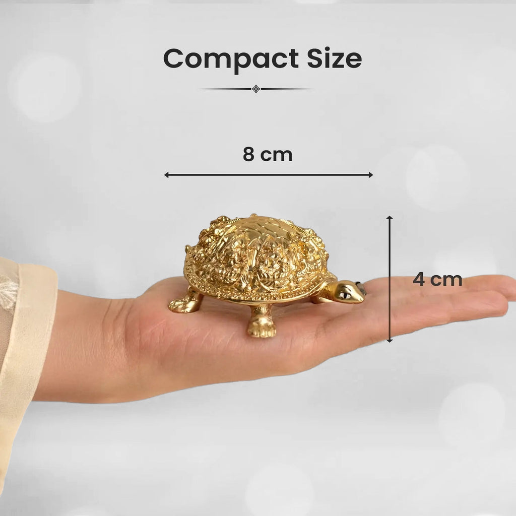 VASTUKOSHA Rinmukteshwar Siddh Ashtalakshmi gold-toned metal tortoise idol held in a palm for scale