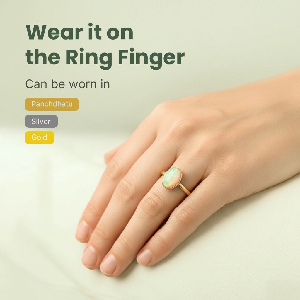 VASTUKOSHA Australian fire opal ring worn on a finger, showcasing the gemstone's natural play of light and gold setting.