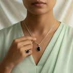 VASTUKOSHA natural black agate oval pendant and matching ring set worn by a woman in a light green top