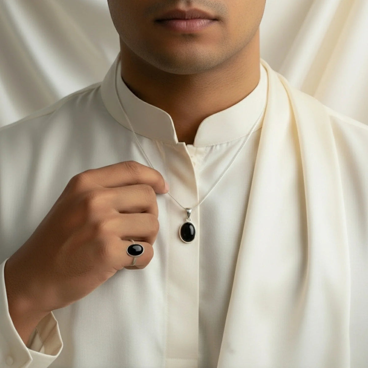 VASTUKOSHA natural black agate pendant necklace and matching ring worn by a man in a white traditional kurta