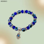 VASTUKOSHA blue evil eye bead bracelet featuring a silver Hamsa hand charm for protective spiritual styling.