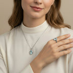 VASTUKOSHA natural blue topaz necklace and ring set worn by a woman in a cream blouse for an elegant look.
