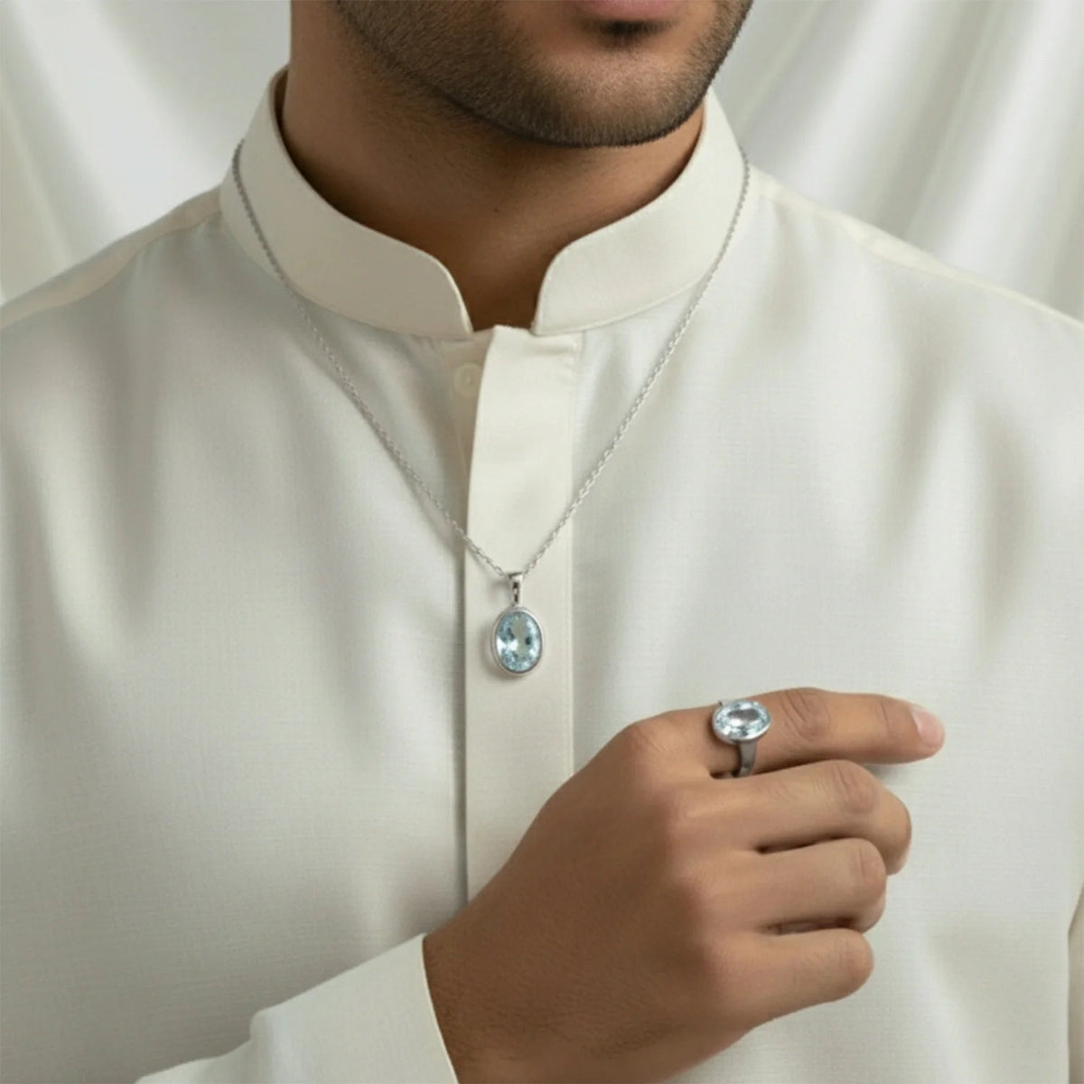 VASTUKOSHA natural blue topaz pendant and ring set worn by a man in a white kurta for spiritual and elegant style