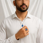 Man wearing a VASTUKOSHA natural Ceylon Neelam blue sapphire pendant and ring set against a white background.