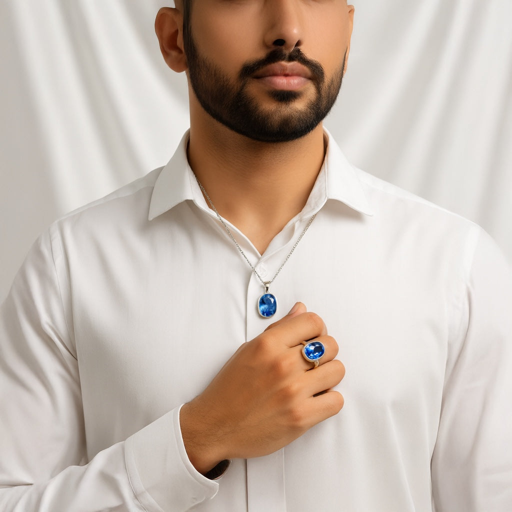 Man wearing a VASTUKOSHA natural Ceylon Neelam blue sapphire pendant and ring set against a white background.