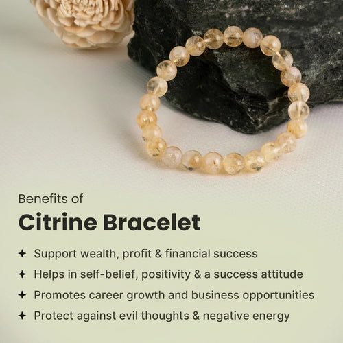VASTUKOSHA Citrine bracelet featuring translucent yellow crystal beads resting on a dark stone surface.