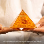 VASTUKOSHA Citrine pyramid with embedded copper spiral held in hands for prosperity and business growth