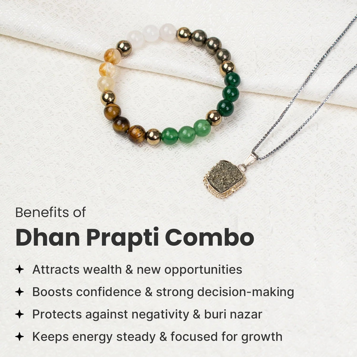 VASTUKOSHA Dhan Prapti crystal bracelet and pyrite pendant necklace set on a white fabric background