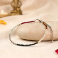 VASTUKOSHA Dhan Yog multi-crystal anklet featuring Pyrite, Citrine, Green Aventurine, Tiger Eye, Obsidian, and Garnet.