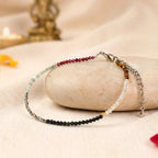 VASTUKOSHA Dhan Yog multi-crystal anklet featuring Pyrite, Citrine, Green Aventurine, Tiger Eye, Obsidian, and Garnet.