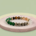 VASTUKOSHA Dhan Yog crystal bracelet featuring Tiger Eye, Pyrite, Citrine, Quartz, Green Aventurine, and Hematite beads.