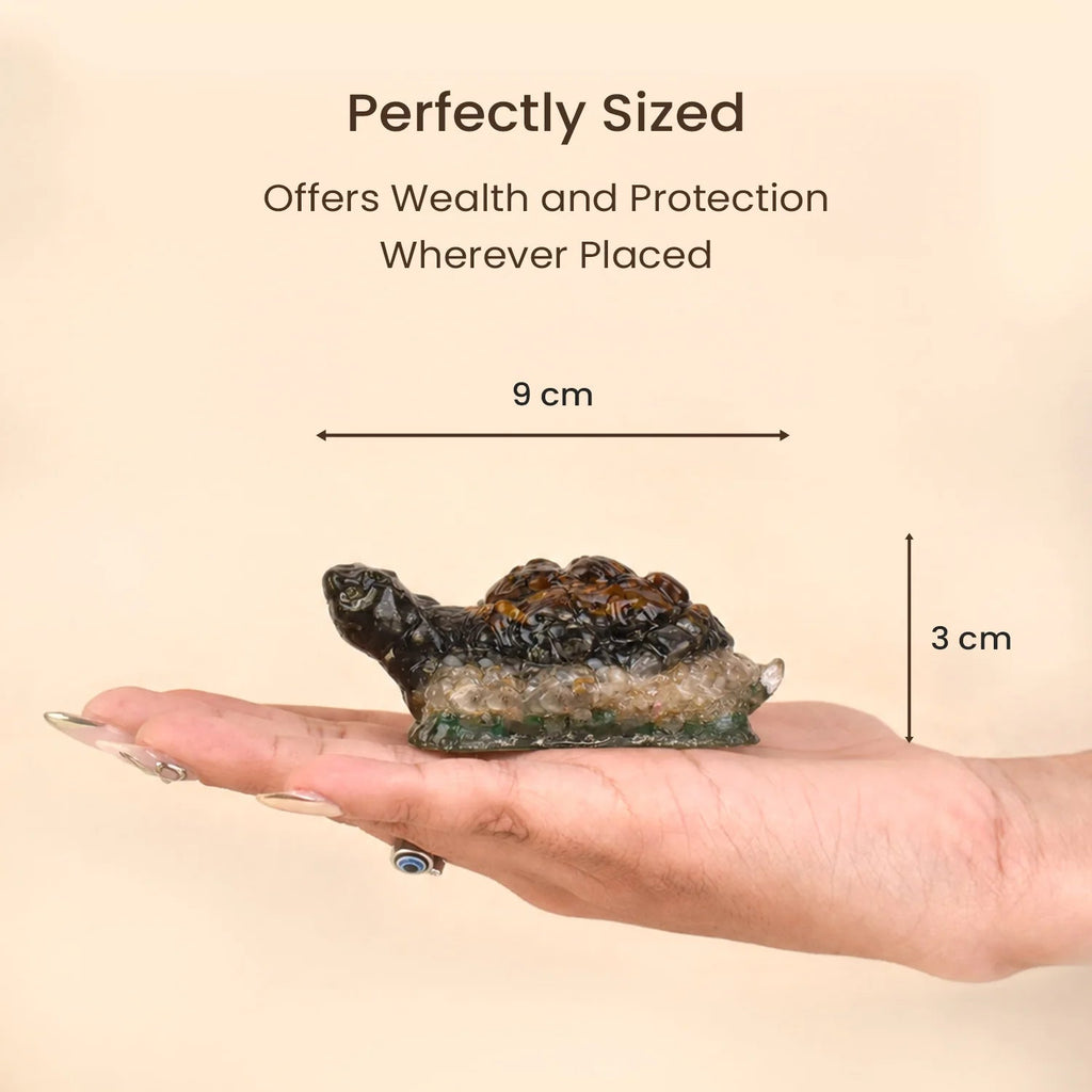VASTUKOSHA Collector's Edition Dhan Yog crystal tortoise held in a hand, showing 9cm by 3cm size for Vastu decor.