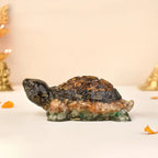 VASTUKOSHA Collector's Edition Dhan Yog tortoise figurine crafted from tiger eye, pyrite, citrine, and green aventurine.