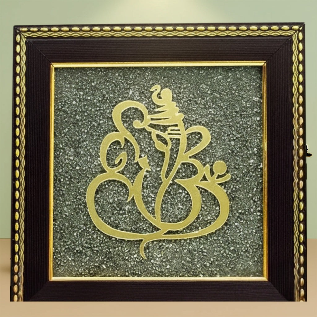 VASTUKOSHA Ganesh Ji wall frame featuring a gold Ganesha motif on a textured raw pyrite background with marigold flowers