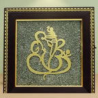 VASTUKOSHA Ganesh Ji wall frame featuring a gold Ganesha motif on a textured raw pyrite background with marigold flowers