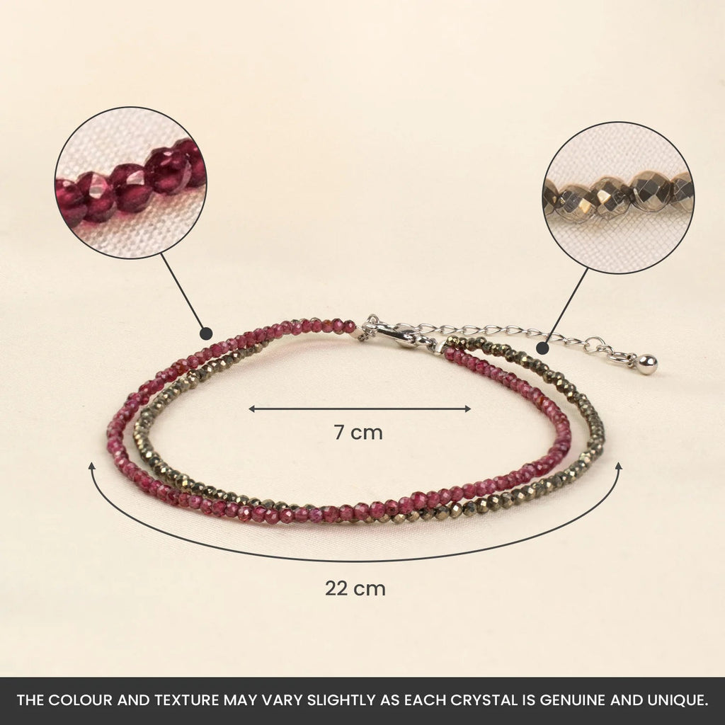 VASTUKOSHA double-layered anklet featuring faceted garnet and pyrite beads with an adjustable chain and hook closure.