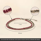 VASTUKOSHA double-layered anklet featuring faceted garnet and pyrite beads with an adjustable chain and hook closure.