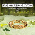 VASTUKOSHA gold-toned metal Dhan Yog bracelet featuring six authentic crystals on a white cloth with a diya lamp