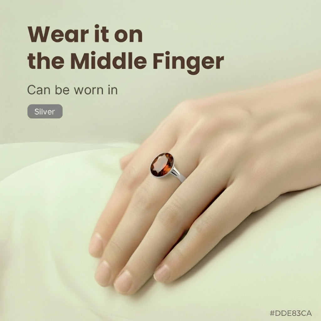 VASTUKOSHA natural hessonite gemstone ring in a silver setting worn on the middle finger for Jyotish practice