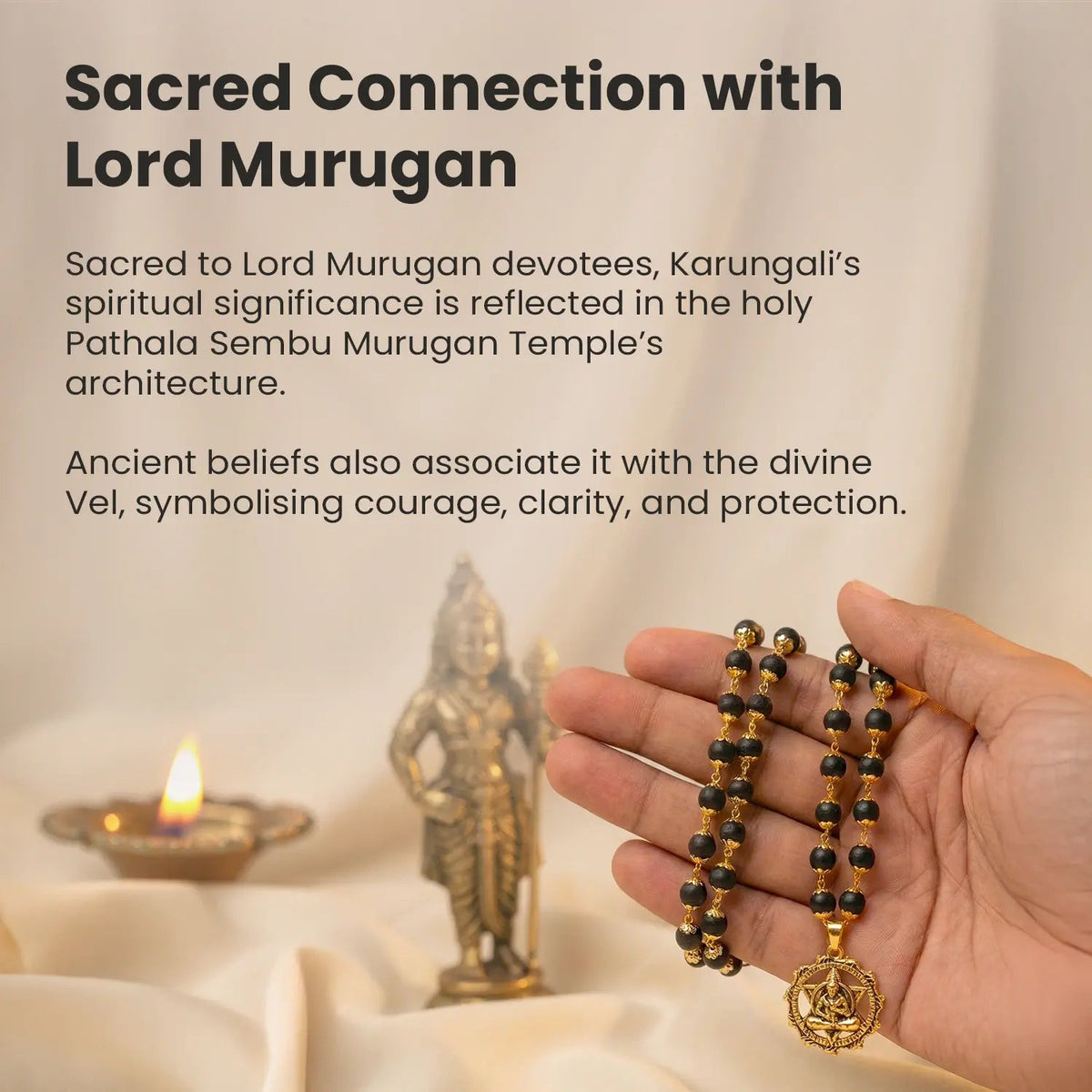 VASTUKOSHA Karungali mala with black ebony beads, gold-plated caps, and a Hanuman Kavach pendant held in a hand.