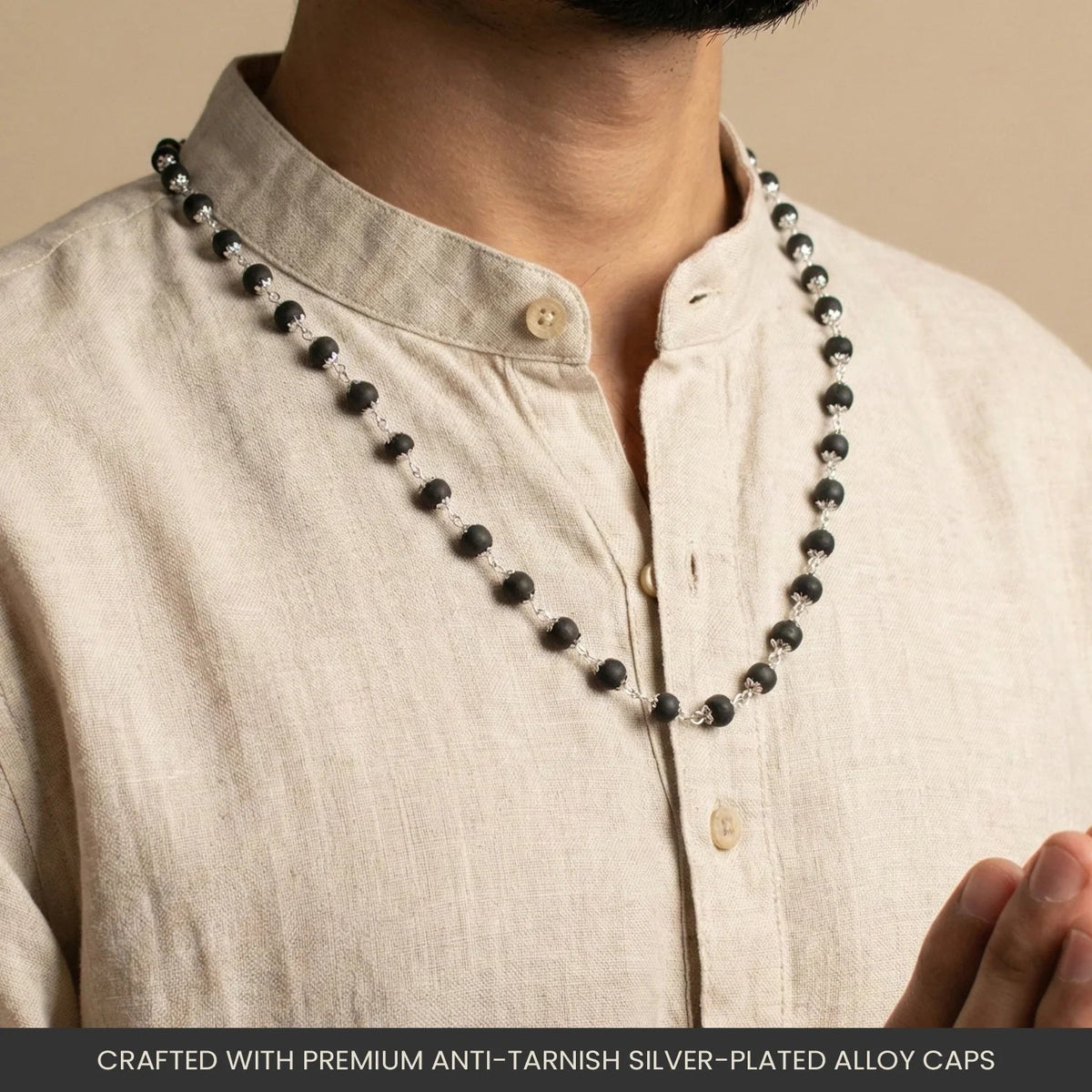 VASTUKOSHA Karungali Mala featuring black ebony wood beads with oxidised silver-plated caps worn by a man in linen