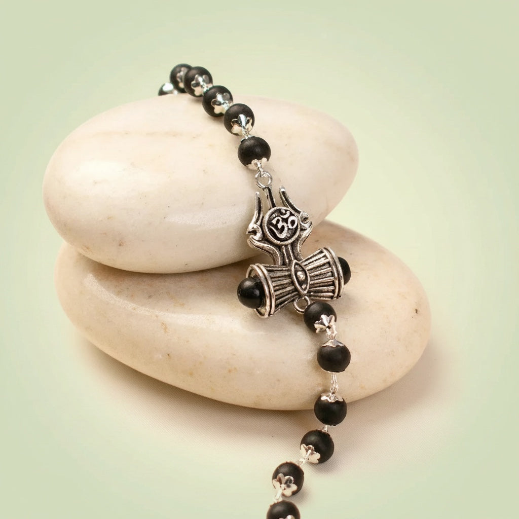 VASTUKOSHA Karungali ebony wood bead bracelet featuring silver Om, Trinetra, Trishul, and Damru Shiva symbols.