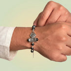 VASTUKOSHA Om Trinetra Trishul Damru Karungali ebony wood bead bracelet worn on a wrist for spiritual practice.
