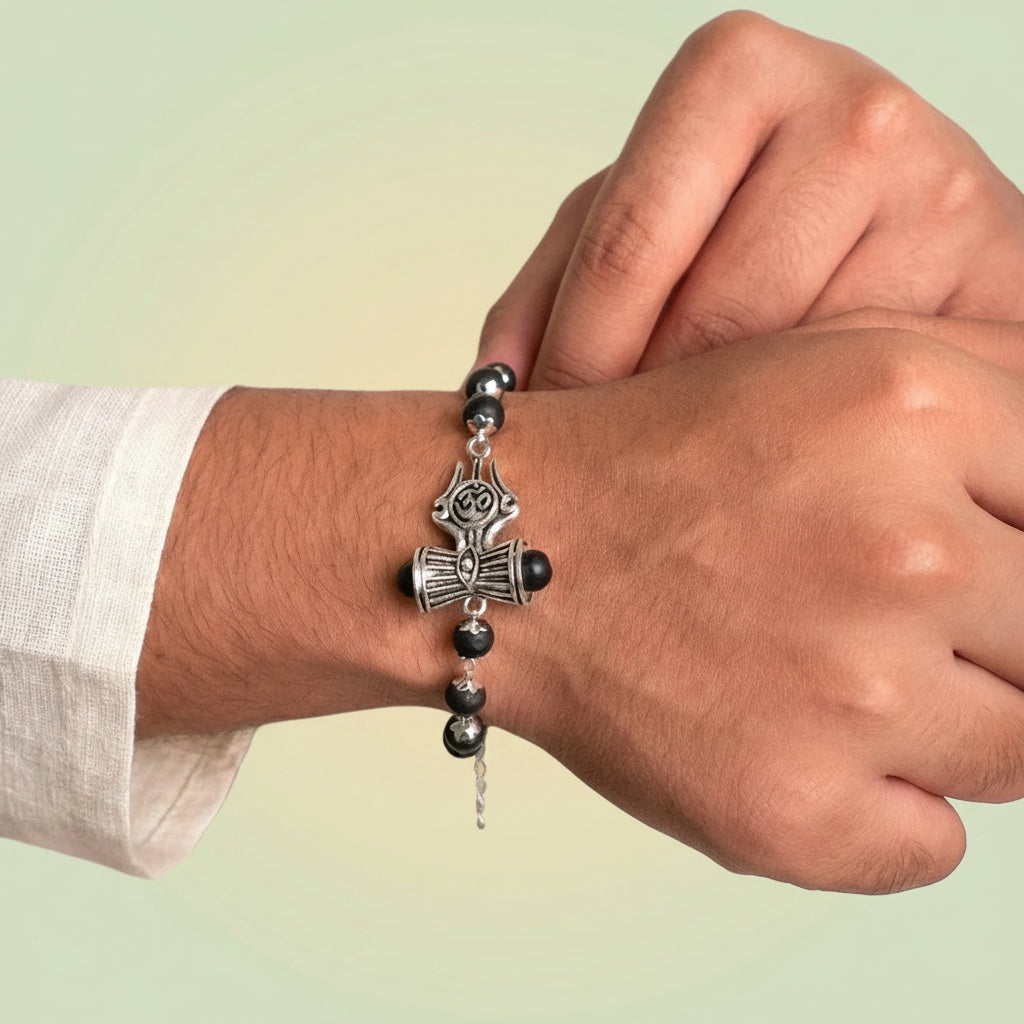 VASTUKOSHA Om Trinetra Trishul Damru Karungali ebony wood bead bracelet worn on a wrist for spiritual practice.