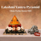 VASTUKOSHA Lakshmi Yantra pyramid with gold accents and seashells alongside a raw metallic pyrite stone for prosperity.