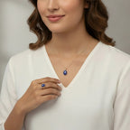 VASTUKOSHA natural lapis lazuli oval pendant necklace and matching ring set worn by a woman in a white top.