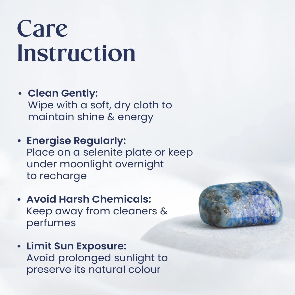 VASTUKOSHA Lapis Lazuli tumble stone with deep blue colour and golden pyrite specks on a white surface