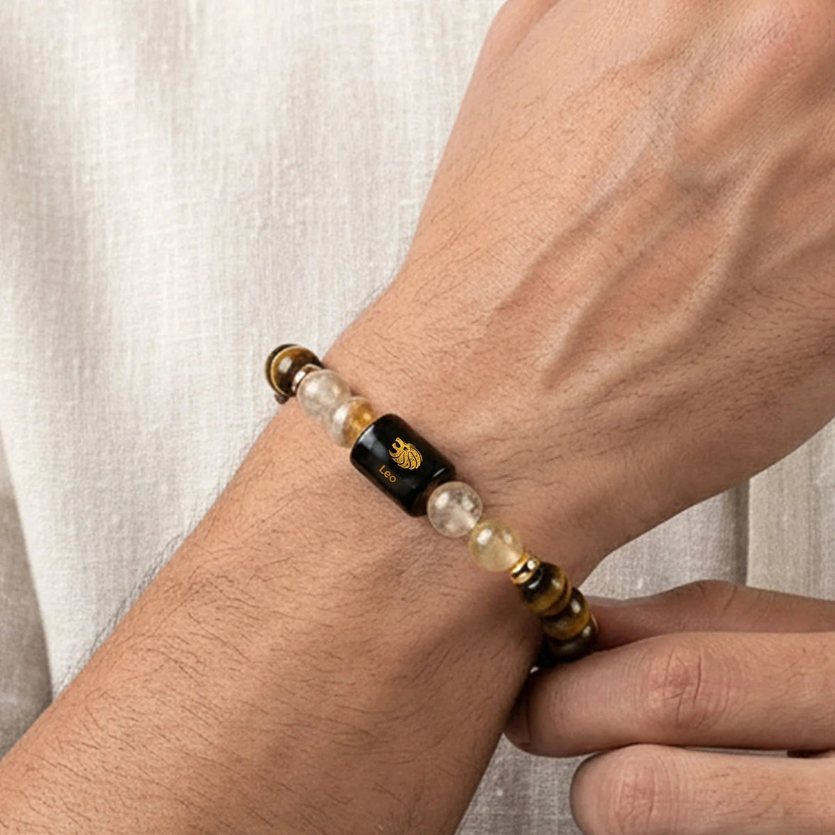 VASTUKOSHA Leo zodiac bracelet featuring tiger eye and citrine beads with a central black bead on a person's wrist.