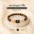 VASTUKOSHA Leo zodiac bracelet featuring brown Tiger Eye and yellow Citrine beads with a central Leo sign charm on a raw Selenite plate.