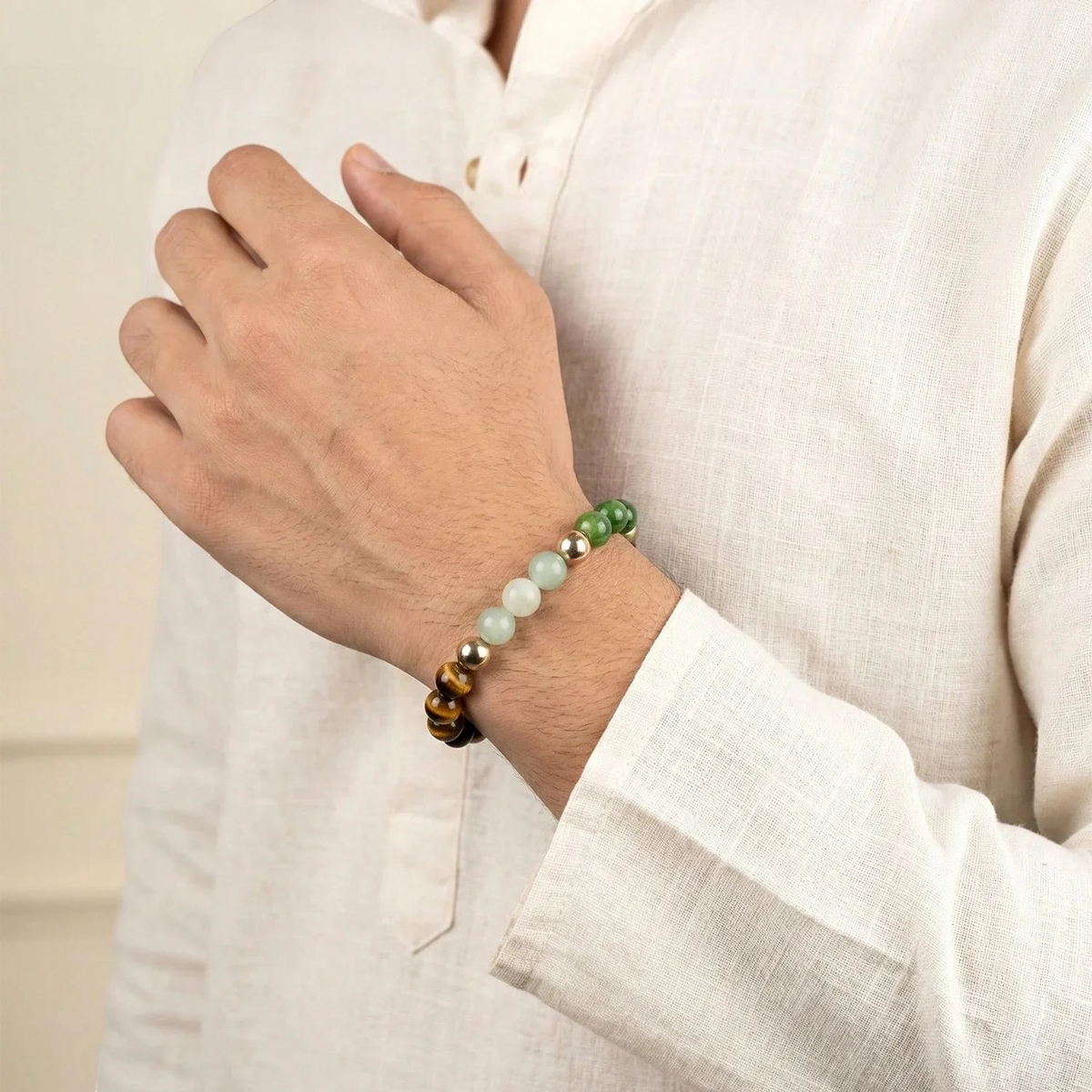 VASTUKOSHA Maha Dhan Yog beaded bracelet featuring natural stones on a man's wrist wearing a white linen shirt