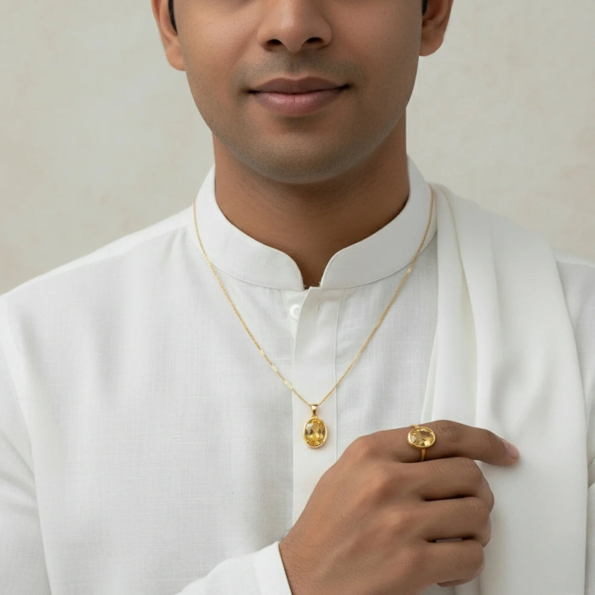 VASTUKOSHA natural citrine gemstone pendant and ring set worn by a man in a white kurta for spiritual practice.