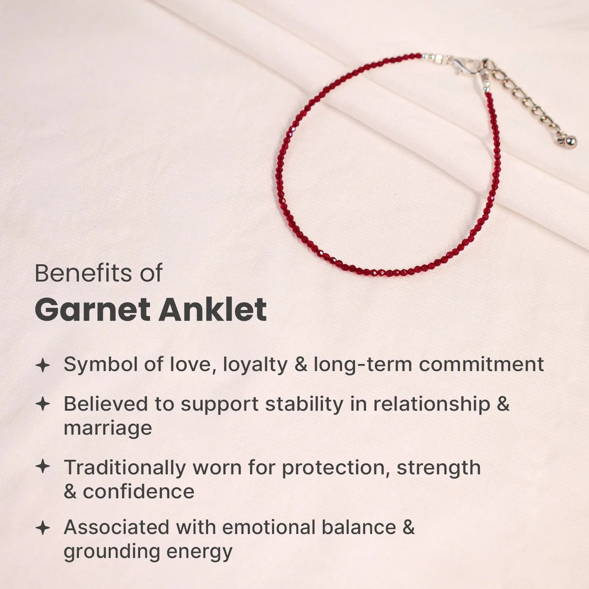 VASTUKOSHA natural deep red garnet beaded anklet with silver clasp on a soft fabric background