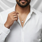 Man wearing a VASTUKOSHA natural zircon gold ring and matching pendant against a white shirt background