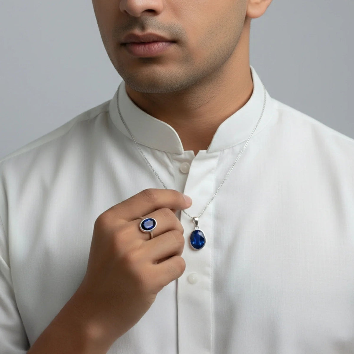 VASTUKOSHA natural Neelam blue sapphire ring and pendant set worn by a man in a white kurta for spiritual practice.