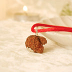 VASTUKOSHA Nepal origin Garbh Gauri Rudraksha pendant on a red thread, featuring a natural brown textured bead.