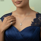 VASTUKOSHA pearl pendant necklace and matching ring worn by a woman in a navy blue dress for spiritual elegance.