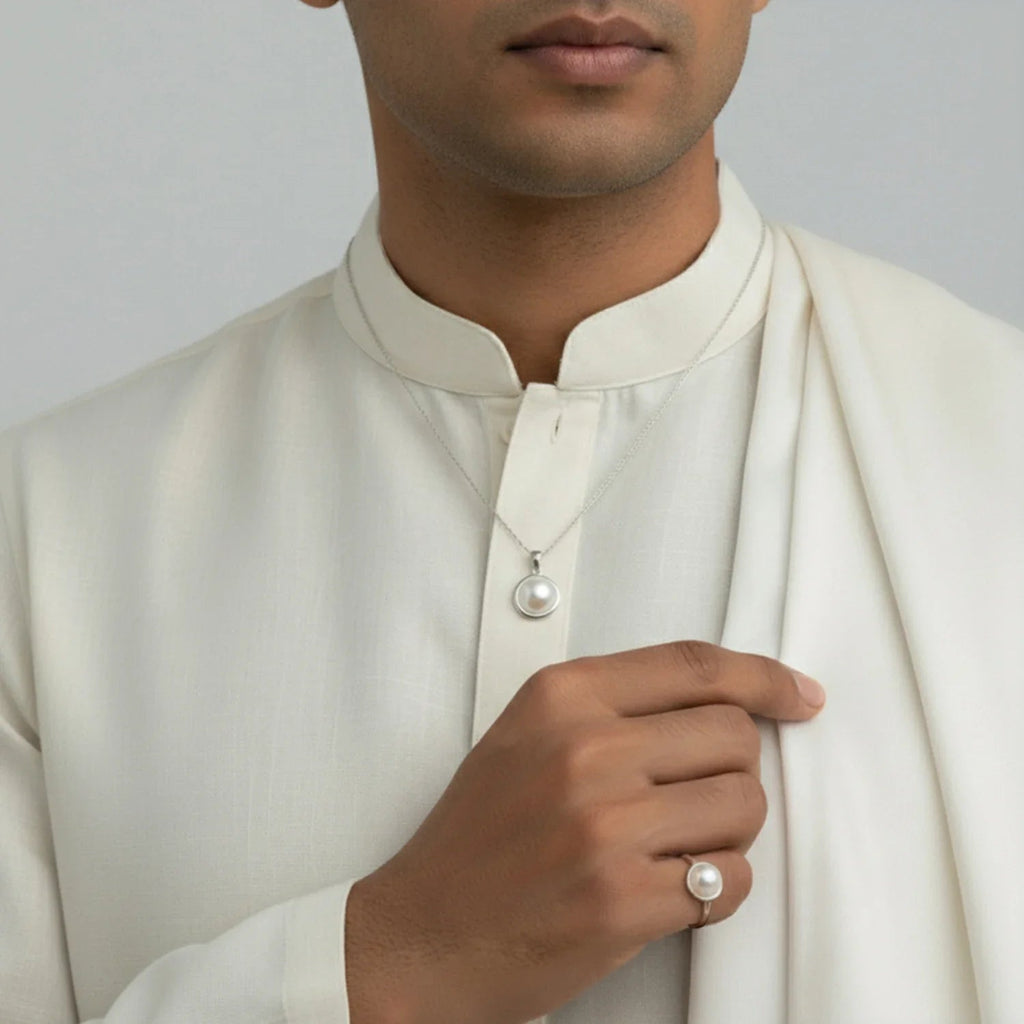 VASTUKOSHA pearl pendant necklace and matching ring worn by a man in a cream-colored traditional kurta